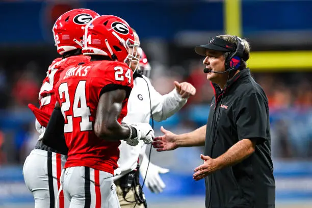 ATLANTA, GA  AUGUST 31:  Georgia head coach Kirby Smart congratulates defensive back Malaki Starks (24) during the Aflac Kickoff Game between the Clemson Tigers and the Georgia Bulldogs on August 31st, 2024 at Mercedes-Benz Stadium in Atlanta, GA.  (Photo by Rich von Biberstein/Icon Sportswire via Getty Images)