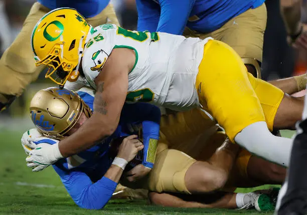 Pasadena, CA - September 28: Oregon defensive tackle Derrick Harmon, #55, sacks UCLA quarterback Ethan Garbers, #4, in the second quarter at the Rose Bowl in Pasadena Saturday, Sept. 28, 2024.  (Allen J. Schaben / Los Angeles Times via Getty Images)