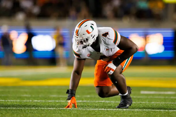 gettyimages-2177244976-612x612 BERKELEY, CALIFORNIA - OCTOBER 5: Rueben Bain Jr. #4 of the Miami Hurricanes in a defensive stance during the first half against California Golden Bears at California Memorial Stadium on October 5, 2024 in Berkeley, California. (Photo by Ric Tapia/Getty Images)