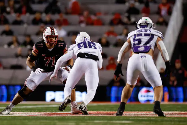 gettyimages-2180837815-612x612 SALT LAKE CITY, UT - OCTOBER 19: Caleb Lomu #71 of the Utah Utes blocks Travis Jackson #96 of the TCU Horned Frogs in the first half at Rice Eccles Stadium on October 19, 2024 in Salt Lake City, Utah. (Photo by Aaron M. Sprecher/Getty Images
