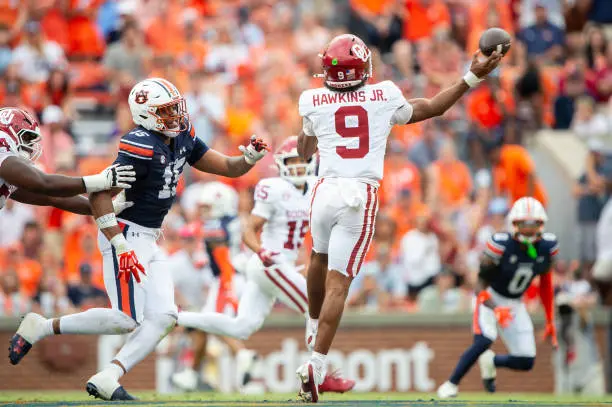 AUBURN, ALABAMA - SEPTEMBER 28: Quarterback Michael Hawkins Jr. #9 of the Oklahoma Sooners throws a pass in front of defensive end Keldric Faulk #15 of the Auburn Tigers at Jordan-Hare Stadium on September 28, 2024 in Auburn, Alabama.  (Photo by Michael Chang/Getty Images)