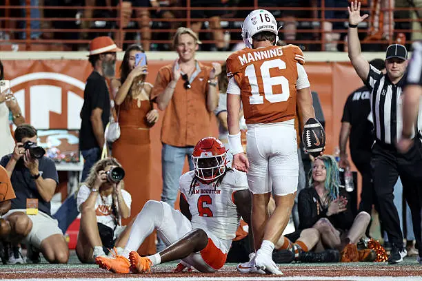 AUSTIN, TEXAS - SEPTEMBER 20: Arch Manning #16 of the Texas Longhorns celebrates in front of Antavious Fish #6 of the Sam Houston State Bearkats after a rushing touchdown in the first quarter at Darrell K Royal-Texas Memorial Stadium on September 20, 2025 in Austin, Texas. (Photo by Tim Warner/Getty Images)