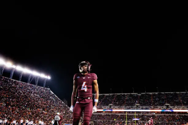 gettyimages-2187776388-612x612 BLACKSBURG, VIRGINIA - NOVEMBER 30: Mansoor Delane #4 of the Virginia Tech Hokies in the second half during a game against the Virginia Cavaliers at Lane Stadium on November 30, 2024 in Blacksburg, Virginia. (Photo by Ryan Hunt/Getty Images)