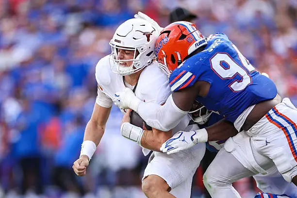 gettyimages-2239261681-612x612 GAINESVILLE, FLORIDA - OCTOBER 04: Arch Manning #16 of the Texas Longhorns is sacked by Tyreak Sapp #94 of the Florida Gators during the second half of a game at Ben Hill Griffin Stadium on October 04, 2025 in Gainesville, Florida. (Photo by James Gilbert/Getty Images)