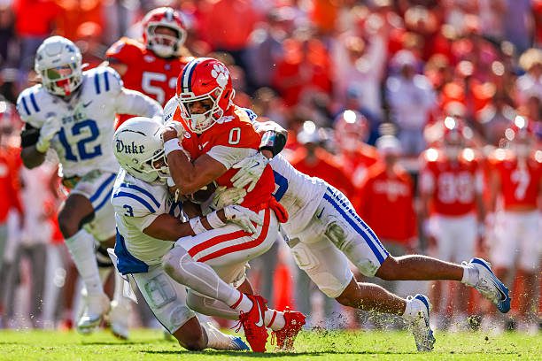 CLEMSON, SOUTH CAROLINA - NOVEMBER 01: Antonio Williams #0 of the Clemson Tigers is tackled by Caleb Weaver #3 and Chandler Rivers #0 of the Duke Blue Devils during the first half of a football game at Memorial Stadium on November 01, 2025 in Clemson, South Carolina. (Photo by David Jensen/Getty Images)