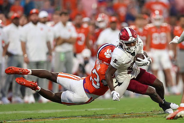 CLEMSON, SOUTH CAROLINA - SEPTEMBER 06: Wide receiver Mojo Dortch #5 of Troy gets tackled by cornerback Ashton Hampton #23 of Clemson during the fourth quarter of a game between Clemson and Troy at Memorial Stadium on September 6, 2025 in Clemson, South Carolina. (Photo by Cory Knowlton/ISI Photos/ISI Photos via Getty Images)