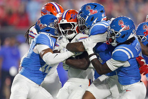 OXFORD, MS - NOVEMBER 15:  Florida Gators running back Jadan Baugh (13) is tackled by a host of Ole Miss Rebels defenders during the college football game between the Florida Gators and Ole Miss Rebels on November 15, 2025, at Vaught-Hemingway Stadium in Oxford, Mississippi. (Photo by Andy Altenburger/Icon Sportswire via Getty Images)