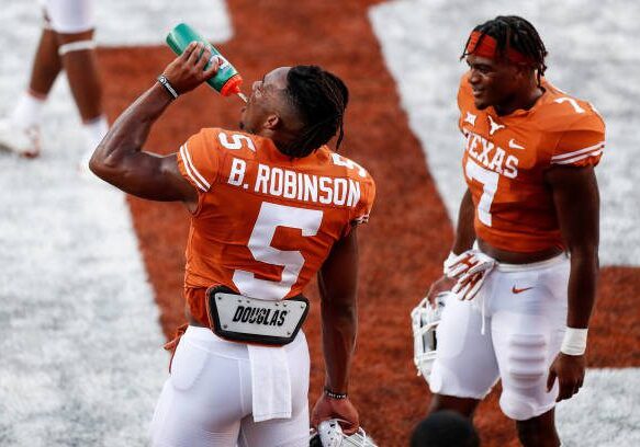 AUSTIN, TEXAS - SEPTEMBER 18: Bijan Robinson #5 of the Texas Longhorns and Keilan Robinson #7 warm up before the game against the Rice Owls at Darrell K Royal-Texas Memorial Stadium on September 18, 2021 in Austin, Texas. (Photo by Tim Warner/Getty Images)