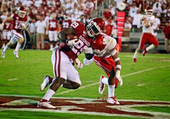 NORMAN, OK - SEPTEMBER 1: Running back Rhamondre Stevenson #29 of the Oklahoma Sooners is hit by safety Gleson Sprewell #21 of the Houston Cougars at Gaylord Family Oklahoma Memorial Stadium on September 1, 2019 in Norman, Oklahoma. The Sooners defeated the Cougars 49-31. (Photo by Brett Deering/Getty Images)