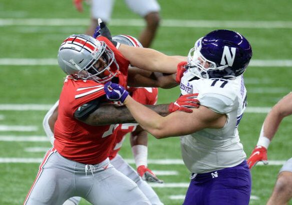 INDIANAPOLIS, IN - DECEMBER 19: Ohio State Buckeyes defensive end Tyreke Smith (11) and Northwestern Wildcats offensive lineman Peter Skoronski (77) battle on the line of scrimmage during the Big Ten Conference Championship football game between the Northwestern Wildcats and the Ohio State Buckeyes on December 19, 2020, at Lucas Oil Stadium in Indianapolis, Indiana. (Photo by Michael Allio/Icon Sportswire via Getty Images)