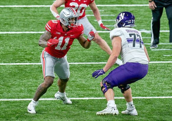 INDIANAPOLIS, IN - DECEMBER 19: Ohio State Buckeyes defensive end Tyreke Smith (11) battles with Northwestern Wildcats offensive lineman Peter Skoronski (77) in action during the Big Ten Championship game between the Ohio State Buckeyes and the Northwestern Wildcats on December 19, 2020 at Lucas Oil stadium, in Indianapolis, IN. (Photo by Robin Alam/Icon Sportswire via Getty Images)