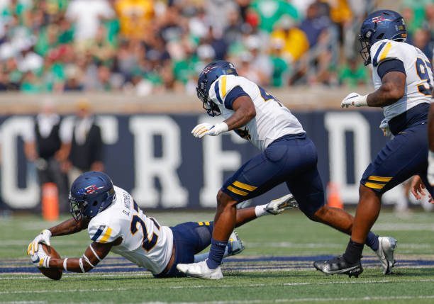 SOUTH BEND, IN - SEPTEMBER 11: Quinyon Mitchell #27 of the Toledo Rockets makes a fumble recovery during the first half against the Notre Dame Fighting Irish at Notre Dame Stadium on September 11, 2021 in South Bend, Indiana. (Photo by Michael Hickey/Getty Images)