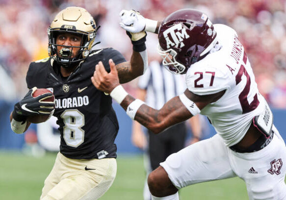 DENVER, CO - SEPTEMBER 11: Alex Fontenot #8 of the Colorado Buffaloes makes a run while being defended by Antonio Johnson #27 of the Texas A&amp;M Aggies during the second quarter at Empower Field At Mile High on September 11, 2021 in Denver, Colorado. (Photo by Michael Ciaglo/Getty Images)