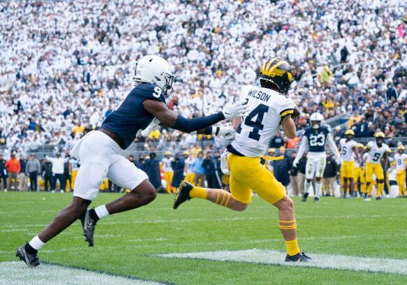 UNIVERSITY PARK, PA - NOVEMBER 13: Michigan Wolverines Wide Receiver Roman Wilson (14) catches a pass for a touchdown with Penn State Nittany Lions Cornerback Joey Porter Jr. (9) defending during the first half of the College Football game between the Michigan Wolverines and the Penn State Nittany Lions on November 13, 2021, at Beaver Stadium in University Park, PA. (Photo by Gregory Fisher/Icon Sportswire via Getty Images)