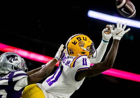 HOUSTON, TX - JANUARY 04: LSU wide receiver Brian Thomas Jr. (11) attempts a catch in the endzone during the TaxAct Texas Bowl game between the Kansas State Wildcats and the LSU Tigers on Tuesday January 4th, 2022 at NRG Stadium in Houston, TX.  (Photo by Nick Tre. Smith/Icon Sportswire via Getty Images)
