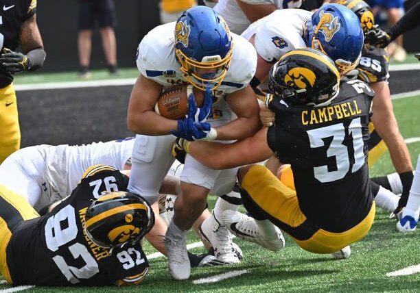 IOWA CITY, IA - SEPTEMBER 03: South Dakota State running back Isiah Davis (22) is tackled by Iowa middle linebacker Jack Campbell (31)during a college football game between the South Dakota State Jackrabbits and the Iowa Hawkeyes, September 03, 2022, at Kinnick Stadium, Iowa City, IA. Photo by Keith Gillett/Icon Sportswire via Getty Images),