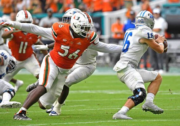 MIAMI GARDENS, FL - SEPTEMBER 24:  Miami defensive lineman Leonard Taylor III (56) pressures Middle Tennessee quarterback Chase Cunningham (16) in the third quarter as the University of Miami Hurricanes faced the Middle Tennessee State University Blue Raiders on September 24, 2022, at Hard Rock Stadium in Miami Gardens, Florida. (Photo by Samuel Lewis/Icon Sportswire via Getty Images)