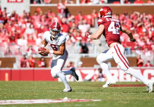 FAYETTEVILLE, AR - OCTOBER 01: Alabama Crimson Tide quarterback Bryce Young (9) is chased down by Arkansas Razorbacks linebacker Drew Sanders (42) during the college football game between the Alabama Crimson Tide and Arkansas Razorbacks on October 1, 2022, at Donald W. Reynolds Razorback Stadium in Fayetteville, Arkansas. (Photo by Andy Altenburger/Icon Sportswire via Getty Images)