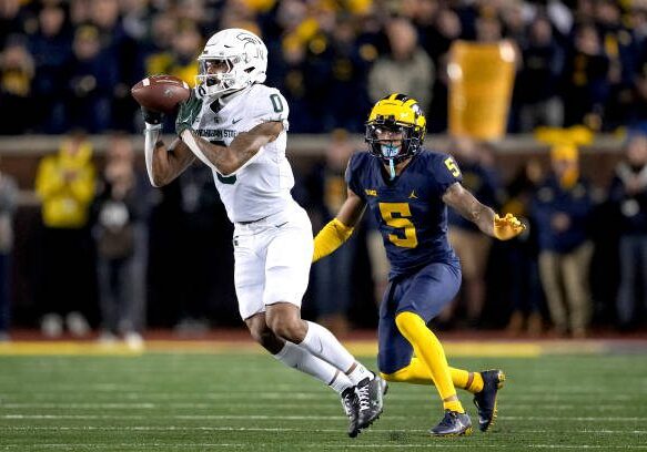 ANN ARBOR, MICHIGAN - OCTOBER 29: Keon Coleman #0 of the Michigan State Spartans receives a pass against DJ Turner #5 of the Michigan Wolverines during the second quarter at Michigan Stadium on October 29, 2022 in Ann Arbor, Michigan. (Photo by Nic Antaya/Getty Images)