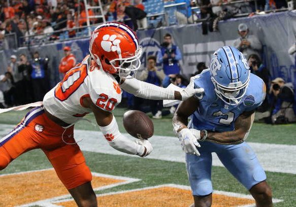 CHARLOTTE, NC - DECEMBER 03: Clemson Tigers corner back Nate Wiggins (20) knocks the ball loose from North Carolina Tar Heels wide receiver Antoine Green (3) for an incomplete pass during the ACC college football championship game between the North Carolina Tar Heels and the Clemson Tigers on December 3, 2022, at Bank of America Stadium in Charlotte, N.C. (Photo by John Byrum/Icon Sportswire via Getty Images)