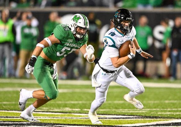 HUNTINGTON, WV - OCTOBER 29, 2022: Grayson McCall #10 of the Coastal Carolina Chanticleers carries the ball during the first half against the Marshall Thundering Herd at Joan C. Edwards Stadium on October 29, 2022 in Huntington, West Virginia. (Photo by Chris Bernacchi/Diamond Images via Getty Images)