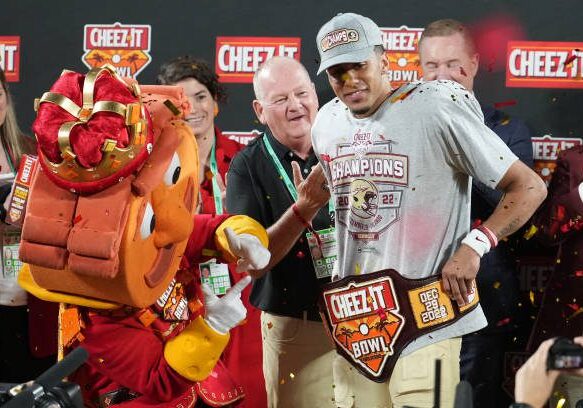 ORLANDO, FL - DECEMBER 29: Florida State Seminoles quarterback Jordan Travis (13) poses with the Cheez-It Bowl MVP trophy following the game between the Oklahoma Sooners and the Florida State Seminoles on Thursday, December 29, 2022 at Camping World Stadium, Orlando, Fla. (Photo by Peter Joneleit/Icon Sportswire via Getty Images)