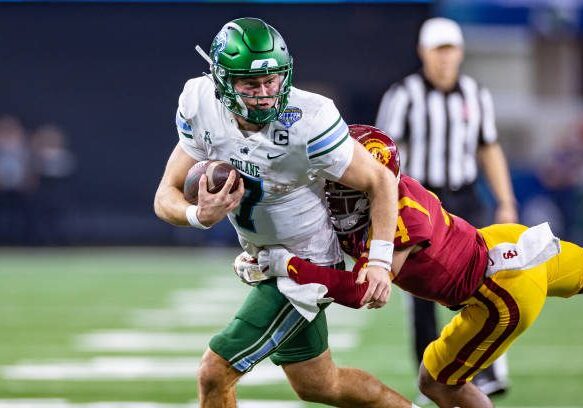 ARLINGTON, TX - JANUARY 02: Tulane Green Wave quarterback Michael Pratt (#7) tries to break away from USC Trojans defensive back Max Williams (#4) during the Goodyear Cotton Bowl game between the USC Trojans and Tulane Green Wave on January 02, 2023 at AT&amp;T Stadium in Arlington, TX.  (Photo by Matthew Visinsky/Icon Sportswire via Getty Images)