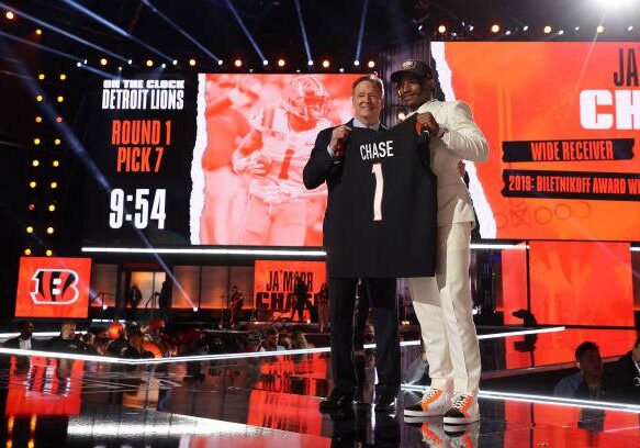 CLEVELAND, OHIO - APRIL 29: Ja'Marr Chase poses with NFL Commissioner Roger Goodell onstage after being selected fifth by the Cincinnati Bengals during round one of the 2021 NFL Draft at the Great Lakes Science Center on April 29, 2021 in Cleveland, Ohio. (Photo by Gregory Shamus/Getty Images)