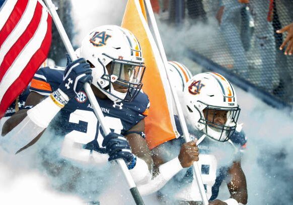 AUBURN, ALABAMA - SEPTEMBER 04: Defensive end Derick Hall #29 of the Auburn Tigers and running back Shaun Shivers #8 of the Auburn Tigers carry flags while running out of their tunnel prior to their game against the Auburn Tigers at Jordan-Hare Stadium on September 04, 2021 in Auburn, Alabama. (Photo by Michael Chang/Getty Images)