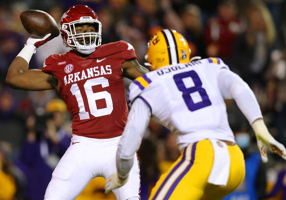 BATON ROUGE, LOUISIANA - NOVEMBER 13: Treylon Burks #16 of the Arkansas Razorbacks throws the ball as BJ Ojulari #8 of the LSU Tigers defends during the fist half of a game at Tiger Stadium on November 13, 2021 in Baton Rouge, Louisiana. (Photo by Jonathan Bachman/Getty Images)