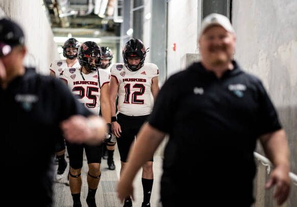 ORLANDO, FLORIDA - DECEMBER 17: Rocky Lombardi #12 and Clint Ratkovich #25 of the Northern Illinois Huskies head to the field before the start of the 2021 Cure Bowl against the Coastal Carolina Chanticleers at Exploria Stadium on December 17, 2021 in Orlando, Florida. (Photo by James Gilbert/Getty Images)