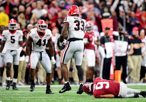 INDIANAPOLIS, INDIANA - JANUARY 10: Robert Beal Jr. #33 of the Georgia Bulldogs reacts to sacking Bryce Young #9 of the Alabama Crimson Tide in the fourth quarter of the game during the 2022 CFP National Championship Game at Lucas Oil Stadium on January 10, 2022 in Indianapolis, Indiana. (Photo by Emilee Chinn/Getty Images)