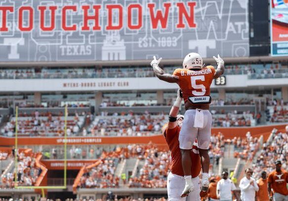 AUSTIN, TEXAS - SEPTEMBER 10: Jake Majors #65 of the Texas Longhorns celebrates with Bijan Robinson #5 after a second quarter touchdown against the Alabama Crimson Tide at Darrell K Royal-Texas Memorial Stadium on September 10, 2022 in Austin, Texas. (Photo by Tim Warner/Getty Images)