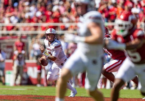 FAYETTEVILLE, ARKANSAS - SEPTEMBER 10: Spencer Rattler #7 of the South Carolina Gamecocks rolls out to pass during a game against the Arkansas Razorbacks at Donald W. Reynolds Razorback Stadium on September 10, 2022 in Fayetteville, Arkansas. The Razorbacks defeated the Gamecocks 44-30.  (Photo by Wesley Hitt/Getty Images)