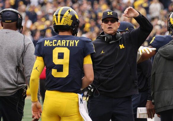 ANN ARBOR, MICHIGAN - SEPTEMBER 24: J.J. McCarthy #9 of the Michigan Wolverines celebrates a second half touchdown with head coach Jim Harbaugh while playing the Maryland Terrapins at Michigan Stadium on September 24, 2022 in Ann Arbor, Michigan. Michigan won the game 34-27. (Photo by Gregory Shamus/Getty Images)