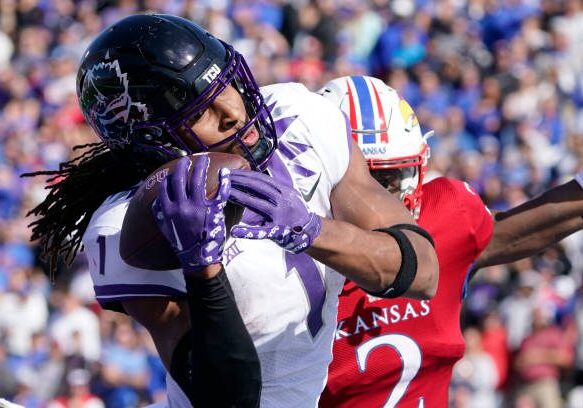 LAWRENCE, KANSAS - OCTOBER 08: Wide receiver Quentin Johnston #1 of the TCU Horned Frogs catches a touchdown pass against Cobee Bryant #2 of the Kansas Jayhawks in the second half at David Booth Kansas Memorial Stadium on October 08, 2022 in Lawrence, Kansas. (Photo by Ed Zurga/Getty Images)