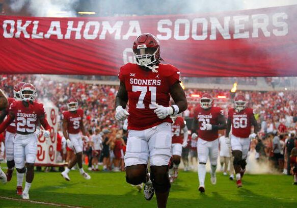 NORMAN, OK - SEPTEMBER 24:  Left tackle Anton Harrison #71 of the Oklahoma Sooners runs onto the field for a game against the Kansas State Wildcats at Gaylord Family Oklahoma Memorial Stadium on September 24, 2022 in Norman, Oklahoma.  Kansas State won 41-34.  (Photo by Brian Bahr/Getty Images)