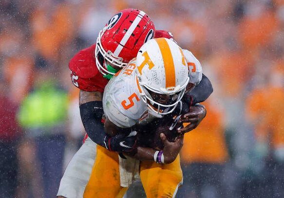 ATHENS, GEORGIA - NOVEMBER 05: Javon Bullard #22 of the Georgia Bulldogs sacks Hendon Hooker #5 of the Tennessee Volunteers during the fourth quarter at Sanford Stadium on November 05, 2022 in Athens, Georgia. (Photo by Todd Kirkland/Getty Images)