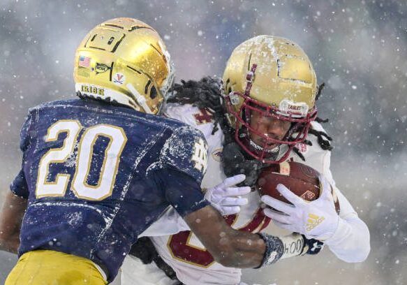 SOUTH BEND, INDIANA - NOVEMBER 19: Taji Johnson #84 of the Boston College Eagles runs for a first down in the second half against Benjamin Morrison #20 of the Notre Dame Fighting Irish at Notre Dame Stadium on November 19, 2022 in South Bend, Indiana. (Photo by Quinn Harris/Getty Images)