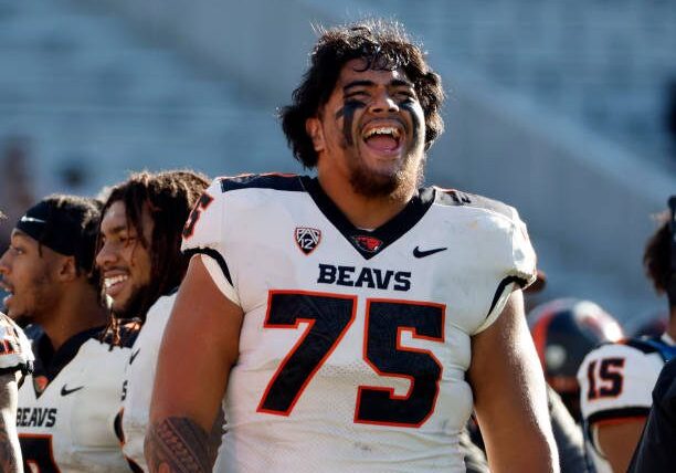 TEMPE, ARIZONA - NOVEMBER 19: Offensive lineman Taliese Fuaga #75 of the Oregon State Beavers smiles on the sidelines during the second half against the Arizona State Sun Devils at Sun Devil Stadium on November 19, 2022 in Tempe, Arizona. The Beavers beat the Sun Devils 31-7. (Photo by Chris Coduto/Getty Images)