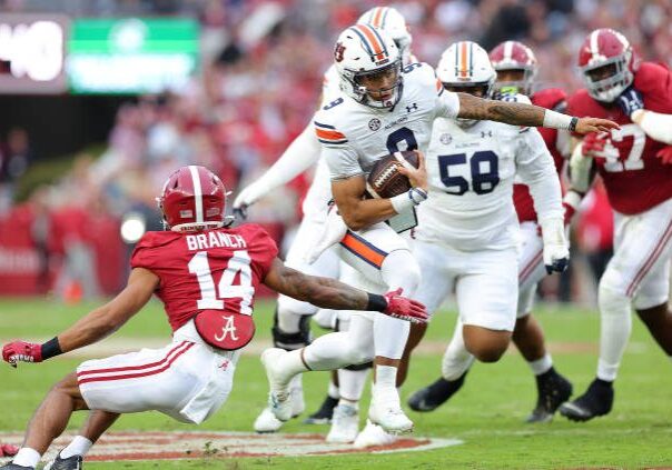 TUSCALOOSA, ALABAMA - NOVEMBER 26:  Robby Ashford #9 of the Auburn Tigers breaks away from Brian Branch #14 of the Alabama Crimson Tide as he rushes for a touchdown during the first half at Bryant-Denny Stadium on November 26, 2022 in Tuscaloosa, Alabama. (Photo by Kevin C. Cox/Getty Images)