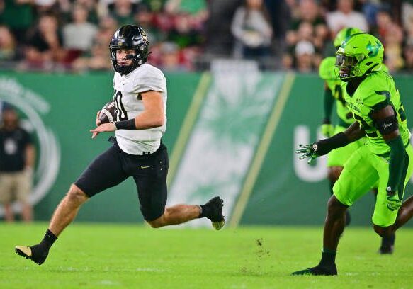 TAMPA, FLORIDA - NOVEMBER 26: John Rhys Plumlee #10 of the UCF Knights runs in a 64-yard touchdown in the first quarter against the South Florida Bulls at Raymond James Stadium on November 26, 2022 in Tampa, Florida. (Photo by Julio Aguilar/Getty Images)