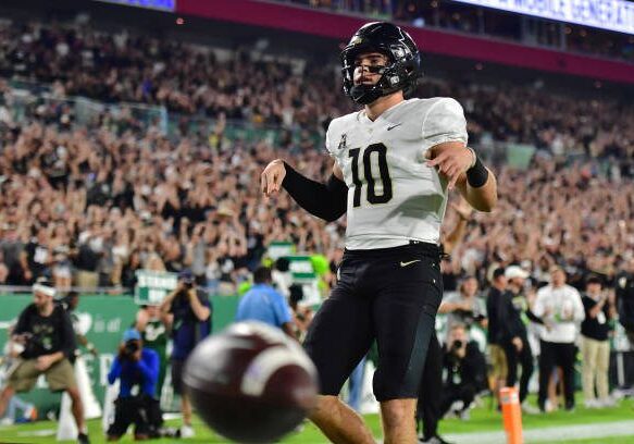 TAMPA, FLORIDA - NOVEMBER 26: John Rhys Plumlee #10 of the UCF Knights reacts after scoring a touchdown in the first half against the South Florida Bulls at Raymond James Stadium on November 26, 2022 in Tampa, Florida. (Photo by Julio Aguilar/Getty Images)