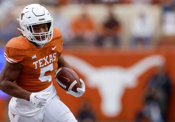 AUSTIN, TEXAS - NOVEMBER 25: Bijan Robinson #5 of the Texas Longhorns runs the ball in the fourth quarter against the Baylor Bears at Darrell K Royal-Texas Memorial Stadium on November 25, 2022 in Austin, Texas. (Photo by Tim Warner/Getty Images)