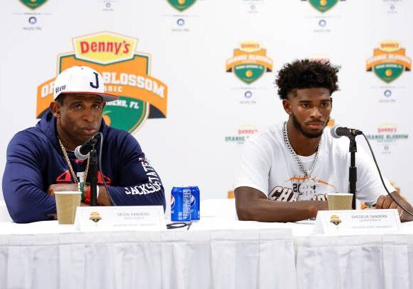 MIAMI GARDENS, FLORIDA - SEPTEMBER 04: Head Coach Deion Sanders and Quarterback Shedeur Sanders #2 of the Jackson State Tigers talk with the media during the post game press conference after the game against the Florida A&amp;M Rattlers during the Denny's Orange Blossom Classic Game at Hard Rock Stadium on September 04, 2022 in Miami Gardens, Florida. The Tigers defeated the Rattlers 59 to 3. (Photo by Don Juan Moore/Getty Images)