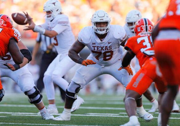 STILLWATER, OK - OCTOBER 22:  Left tackle Kelvin Banks Jr. #78 of the Texas Longhorns blocks for quarterback Quinn Ewers #3 against defensive end Collin Oliver #30 of the Oklahoma State Cowboys in the third quarter at Boone Pickens Stadium on October 22, 2022 in Stillwater, Oklahoma.  Oklahoma State won 41-34.  (Photo by Brian Bahr/Getty Images)