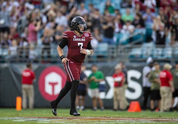 JACKSONVILLE, FLORIDA - DECEMBER 30: Spencer Rattler #7 of the South Carolina Gamecocks looks on during the first half of the TaxSlayer Gator Bowl against the Notre Dame Fighting Irish at TIAA Bank Field on December 30, 2022 in Jacksonville, Florida. (Photo by James Gilbert/Getty Images)