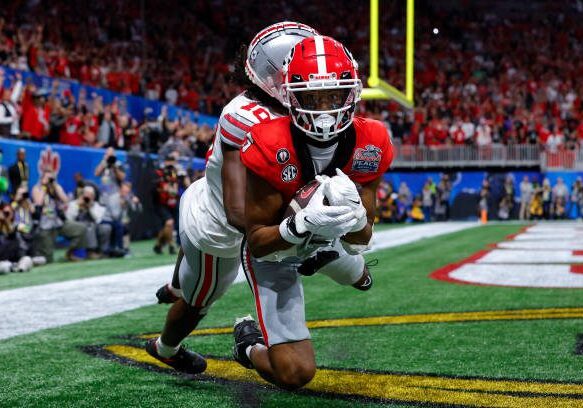 ATLANTA, GA - DECEMBER 31: Adonai Mitchell #5 of the Georgia Bulldogs catches a touchdown pass against Denzel Burke #10 of the Ohio State Buckeyes during the fourth quarter in the Chick-fil-A Peach Bowl at Mercedes-Benz Stadium on December 31, 2022 in Atlanta, Georgia. (Photo by Todd Kirkland/Getty Images)