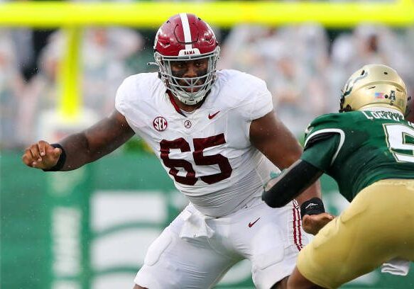 TAMPA, FL - SEPTEMBER 16: Alabama Offensive Lineman JC Latham (65) pass blocks during the College Football game between the Alabama Crimson Tide and the South Florida Bulls on September 16, 2023 at Raymond James Stadium in Tampa, FL. (Photo by Cliff Welch/Icon Sportswire via Getty Images)