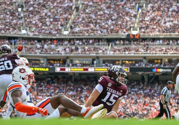 COLLEGE STATION, TX - SEPTEMBER 23: Texas A&amp;M Aggies quarterback Conner Weigman (15) grimaces in pain after taking a hit from Auburn Tigers cornerback Jaylin Simpson (36) just before halftime during the football game between the Auburn Tigers and Texas A&amp;M Aggies at Kyle Field on September 23, 2023, in College Station, Texas. (Photo by Ken Murray/Icon Sportswire via Getty Images)